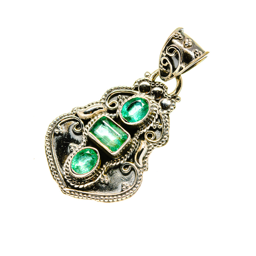 Ornate sterling silver pendant with three green gemstones and pointed bail loop.