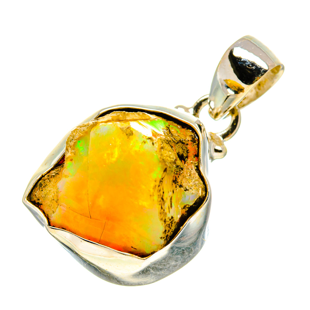 Rough opal pendant with silver bail; yellow-orange stone with green flashes.