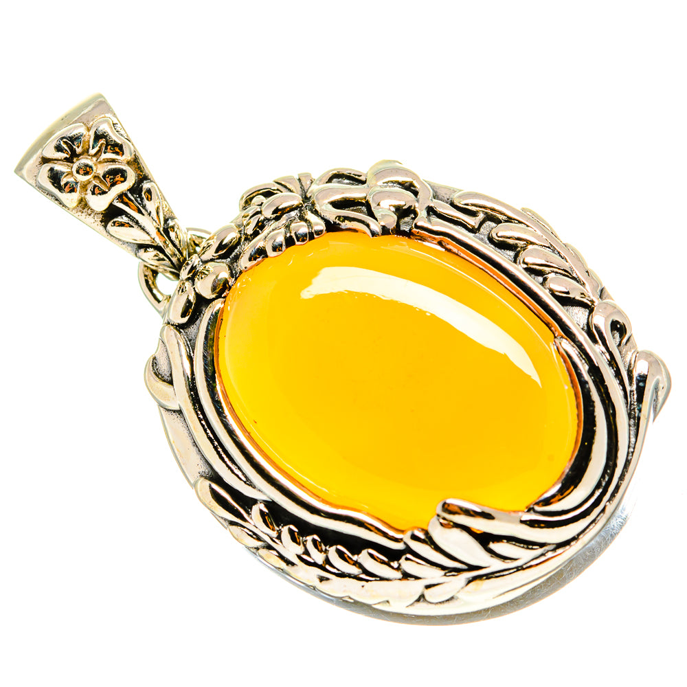 Sterling silver moonstone pendant with yellow oval cabochon and filigree border