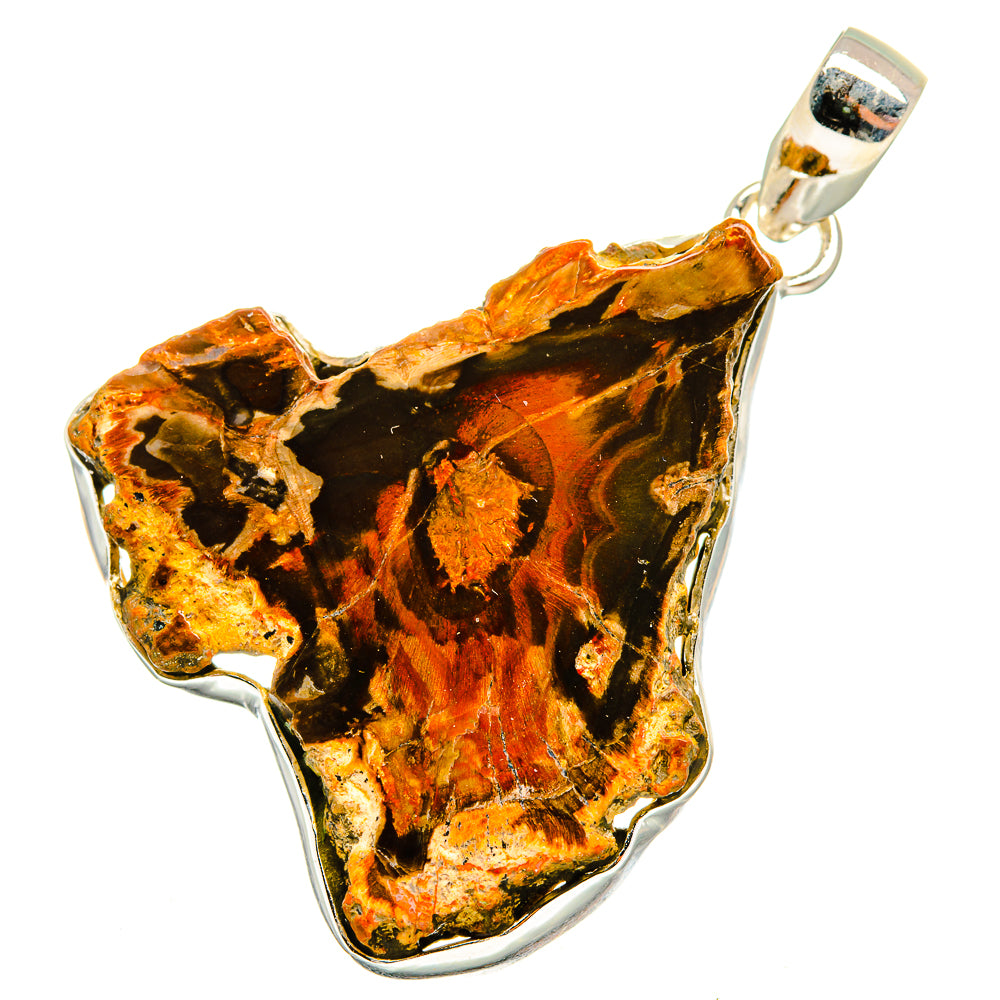 Petrified wood pendant with vivid amber, black, and orange patterns, framed in silver