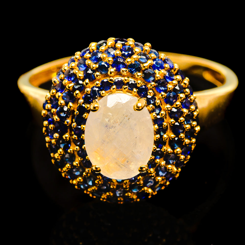 14K yellow gold ring with oval opal-like moonstone center, blue sapphire halo
