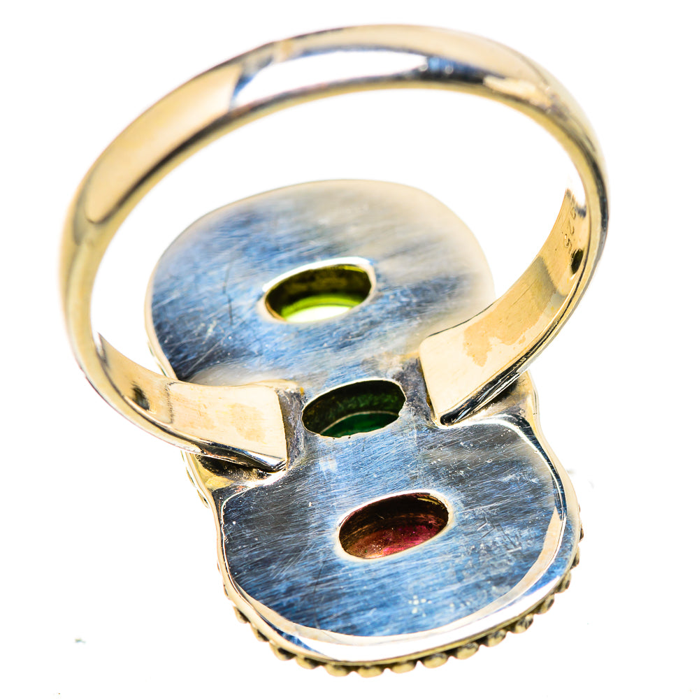 Silver ring band with oval tourmaline settings on top, open bezel backs visible