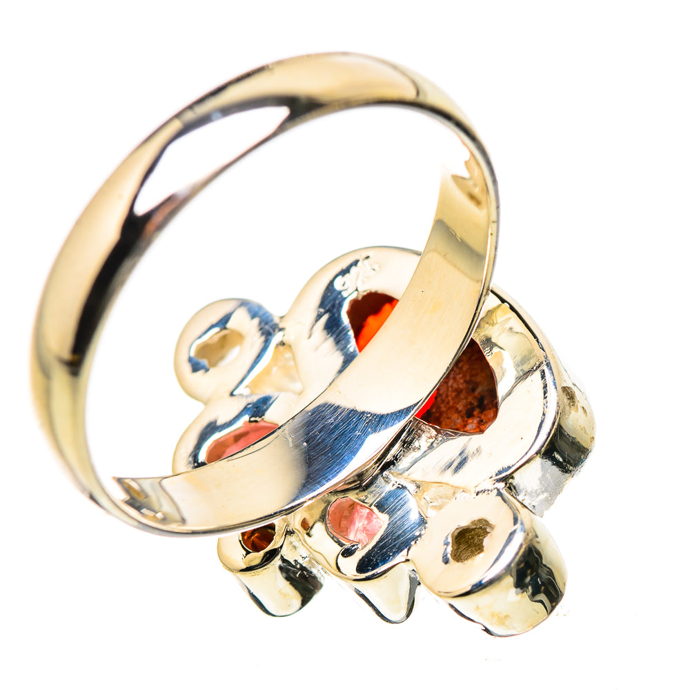 Gold-tone ring with oval red gemstone and blue/pink inlay