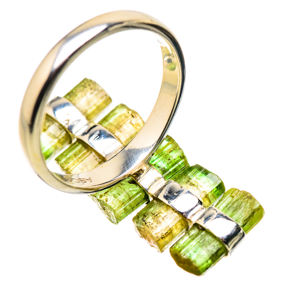 Silver ring with green tourmaline baguette stones and reflective metal prong details