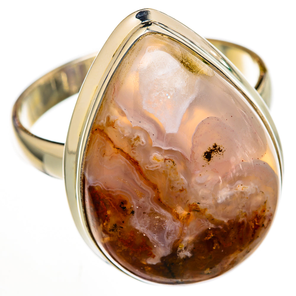 Metal band oval ocean jasper cabochon ring with translucent white and amber rust patches.