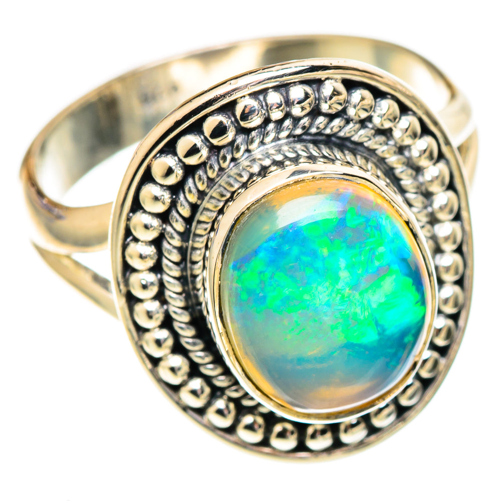 Oval opal ring in silver with ornate bead bezel and blue-green iridescence