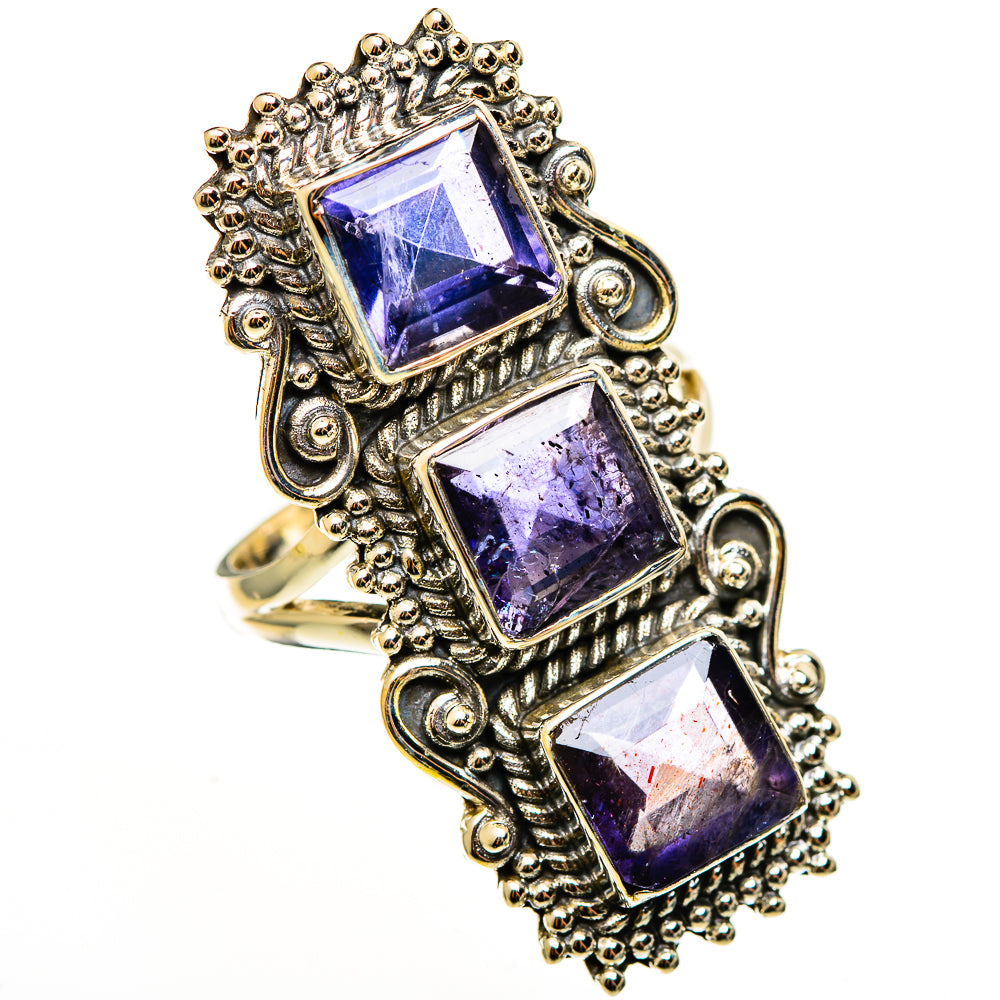 Ornate statement ring with three faceted purple gemstones in silver-tone frames
