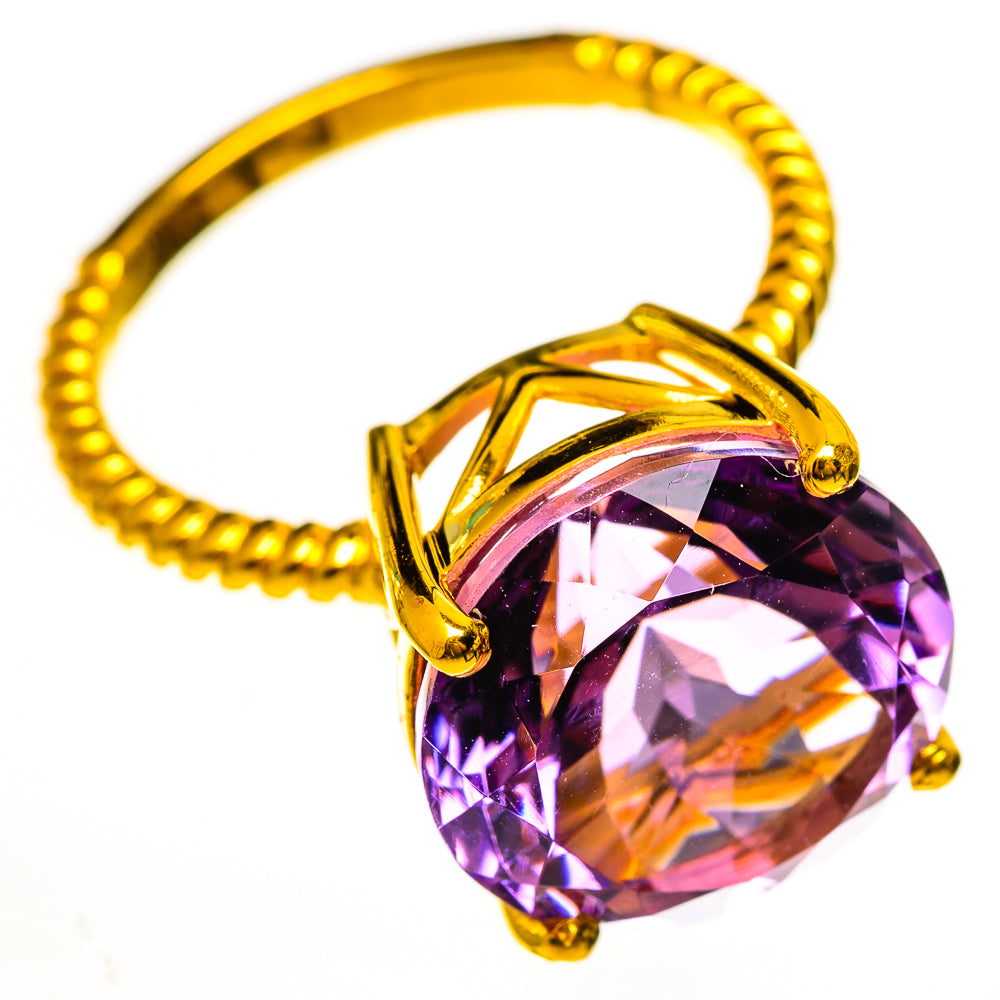 Gold-tone amethyst ring with large faceted round stone and four prongs