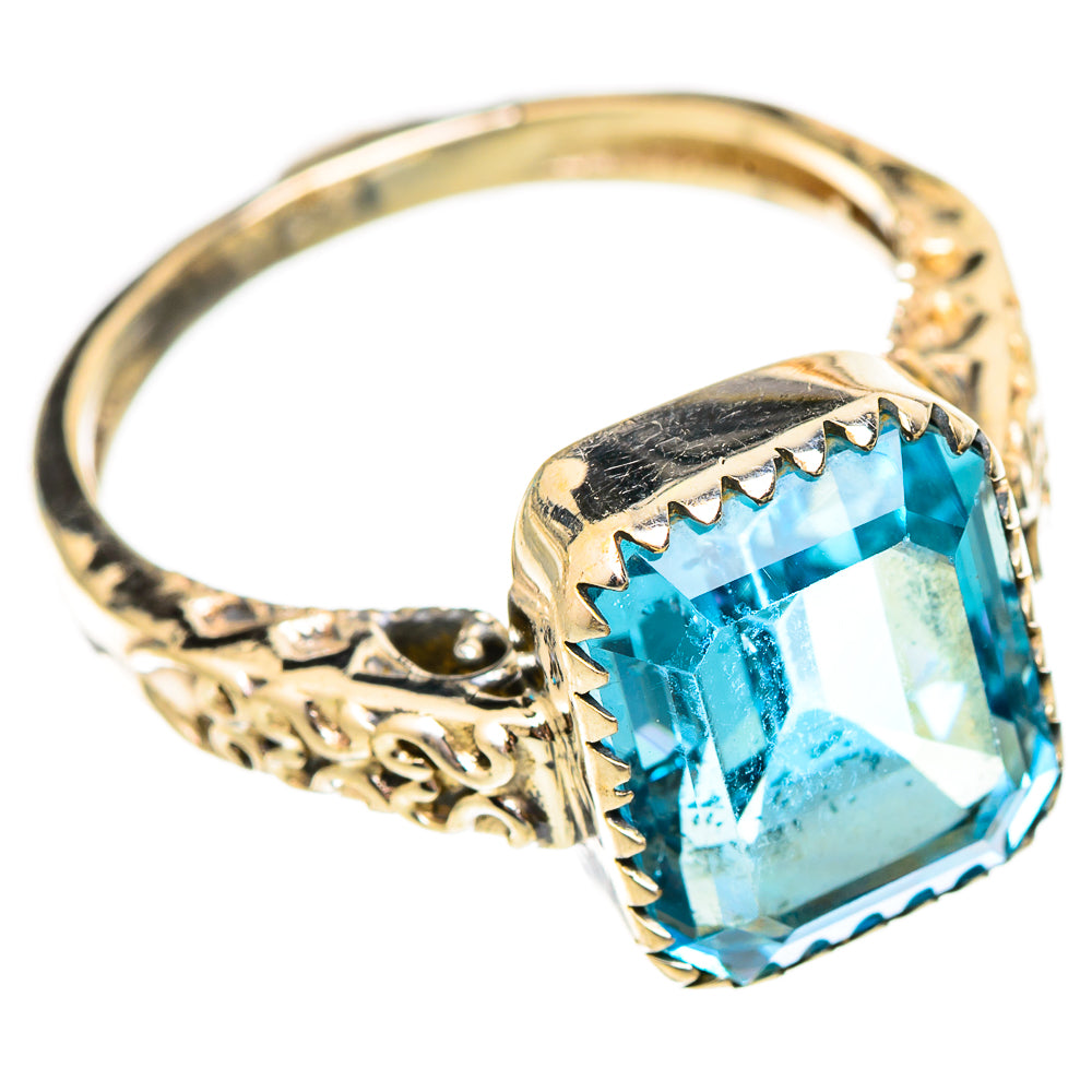 Blue topaz sterling silver ring with ornate scrollwork, square-cut gemstone detail.