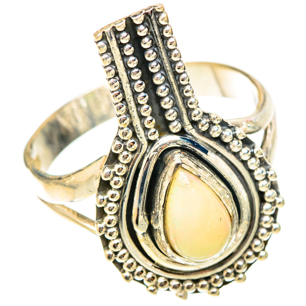 Silver opal ring with teardrop-shaped yellow center, ridged bezel and bead border