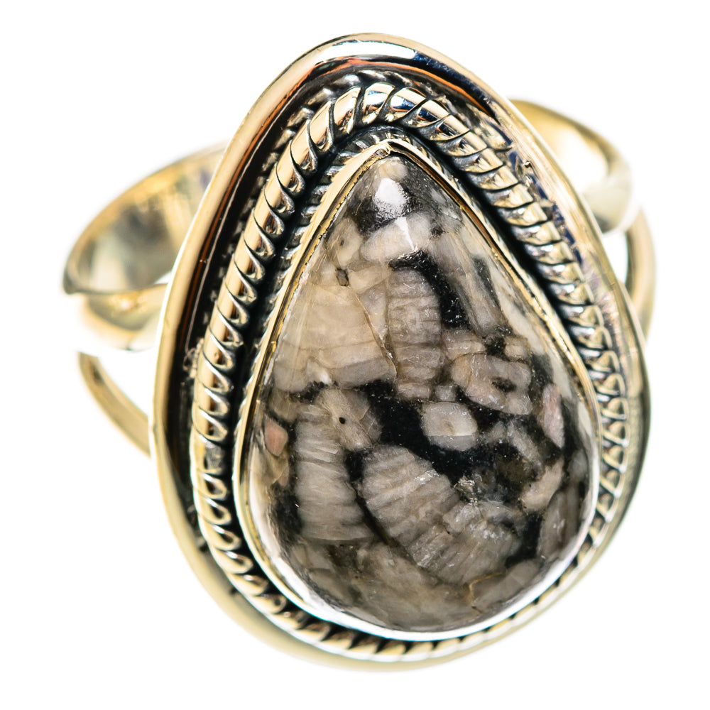 Crinoid fossil ring, teardrop cabochon with black-and-gray stone and detailed silver frame