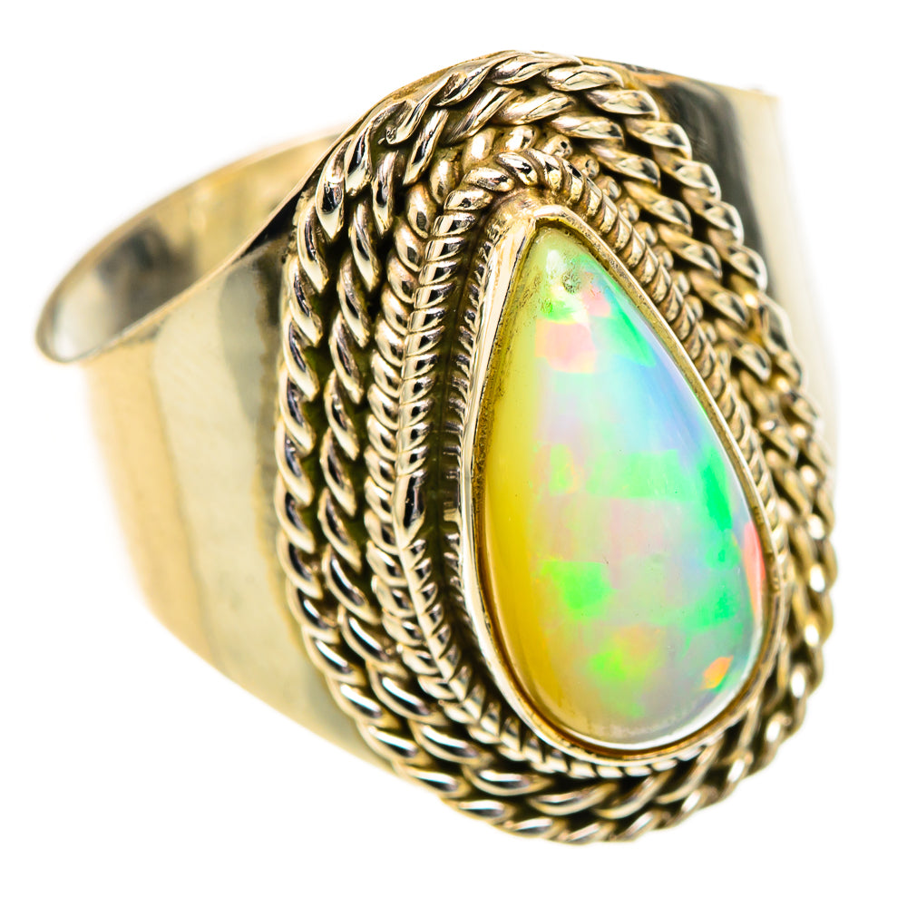 Braided metal opal teardrop ring with scalloped bezel setting