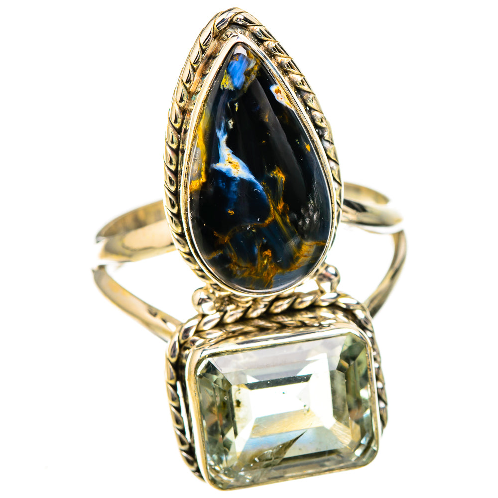 Ornate teardrop ring with dark blue stone and rectangular clear faceted stone on metal band