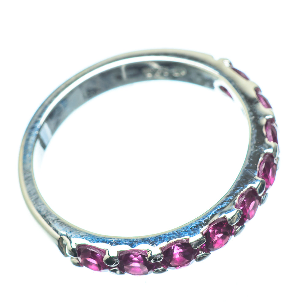 925 sterling silver ring with pink gemstones set along the band
