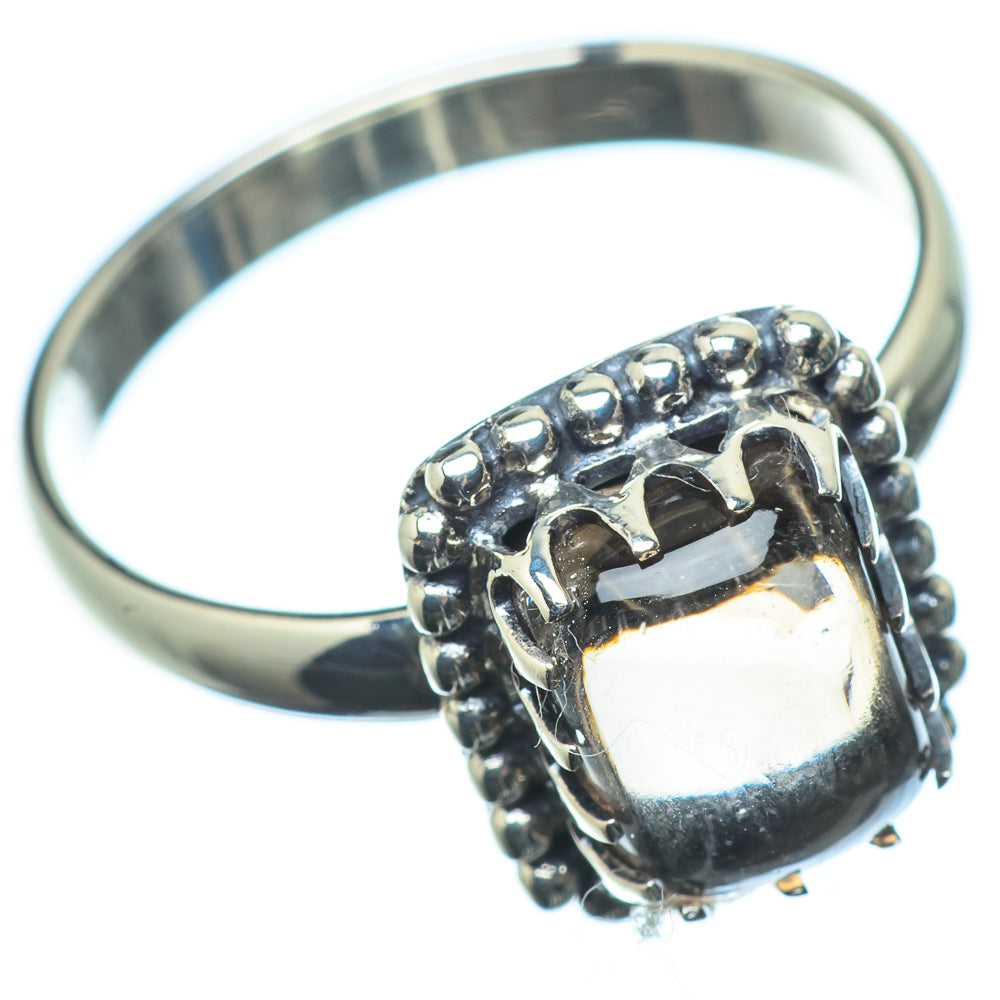 925 sterling silver ring with dark oval gemstone set in bezel, raised bead border