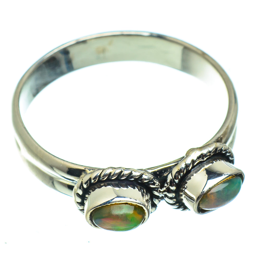 Opal sterling silver ring with two oval stones on twisted band, openwork sides.