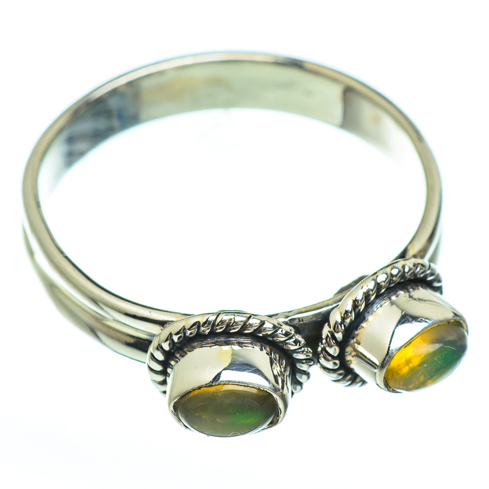 Sterling silver opal ring with two oval yellow-green stones on raised rope settings