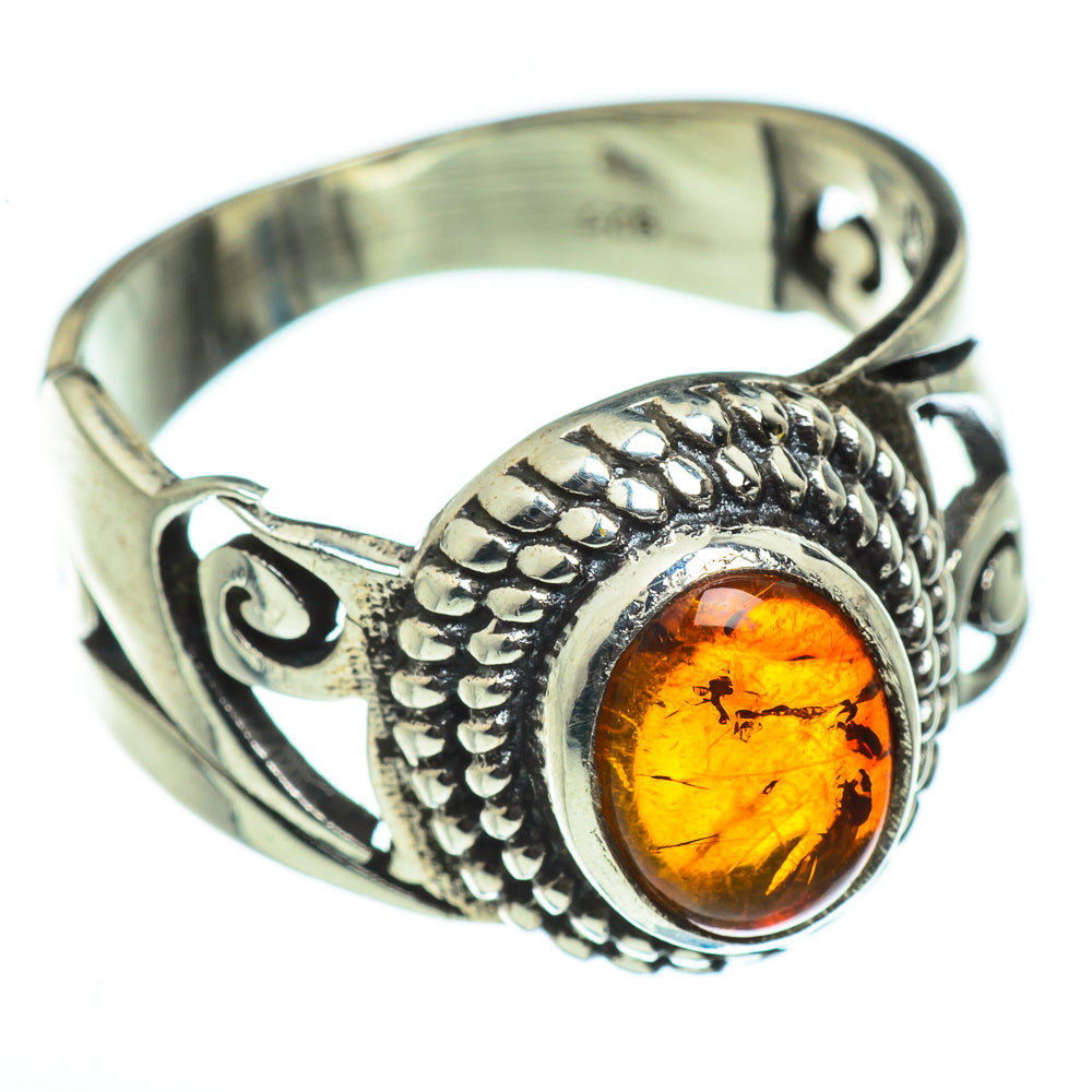 Sterling silver amber ring with oval orange Baltic amber stone and carved leaf motifs