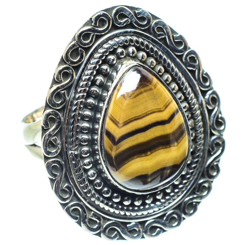 Sterling silver oval gemstone ring with tiger eye stripes and ornate raised bezel