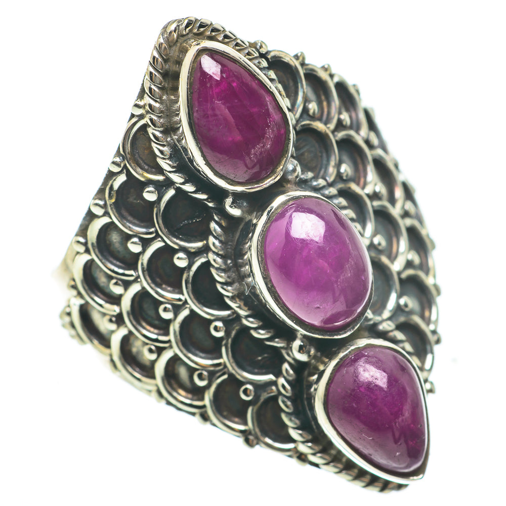 Silver statement ring with three oval purple cabochon gemstones on filigree band