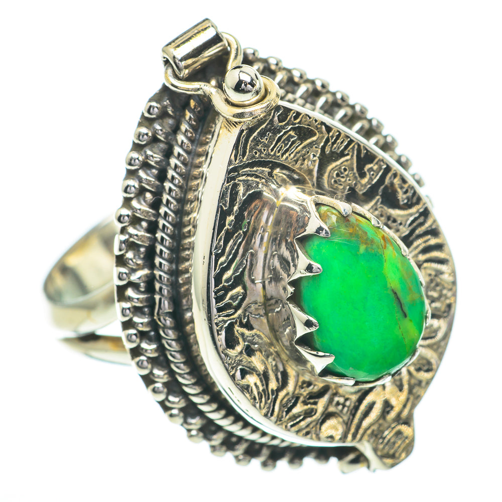 Sterling silver ring with raised green oval cabochon and decorative engraved frame