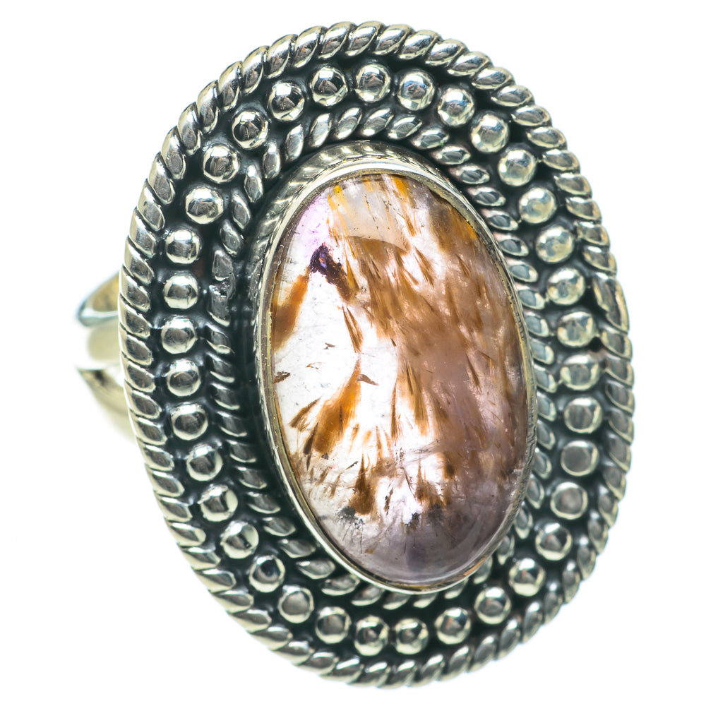 Sterling silver ring with oval gemstone cabochon, golden inclusions, and bead bezel