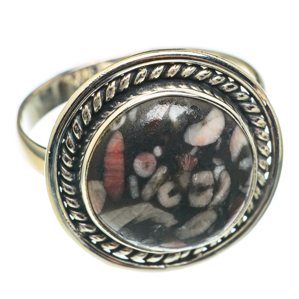 Sterling silver ring with round bezel set dark fossil cabochon and engraved border