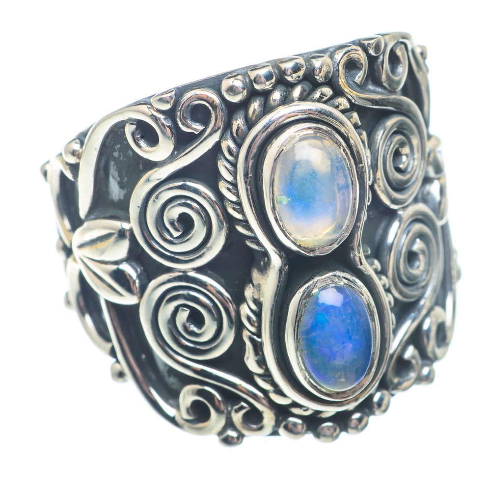 Sterling silver opal ring with oval blue opal cabochons and decorative swirl bezel