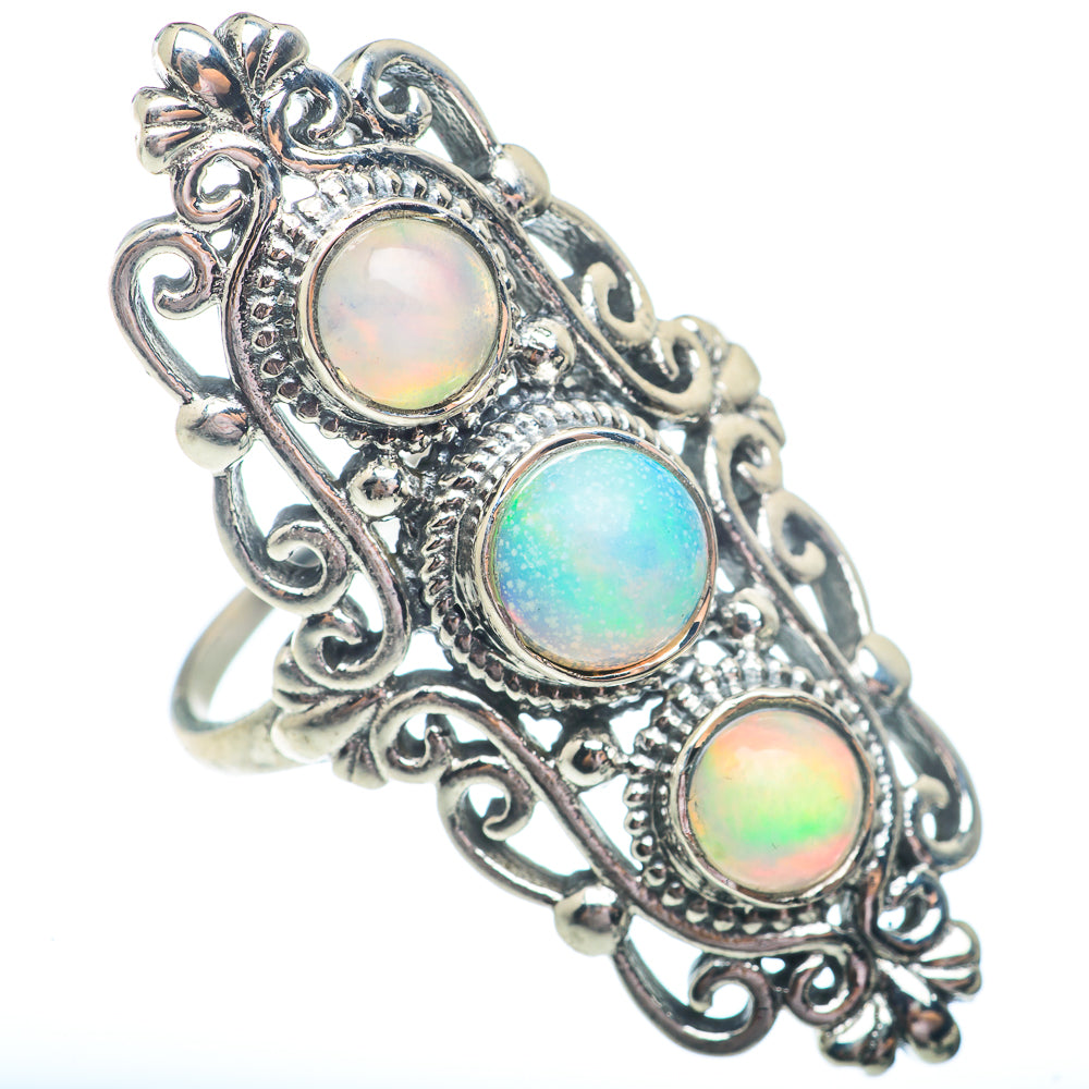 Sterling silver opal ring with three iridescent round stones and detailed scroll setting