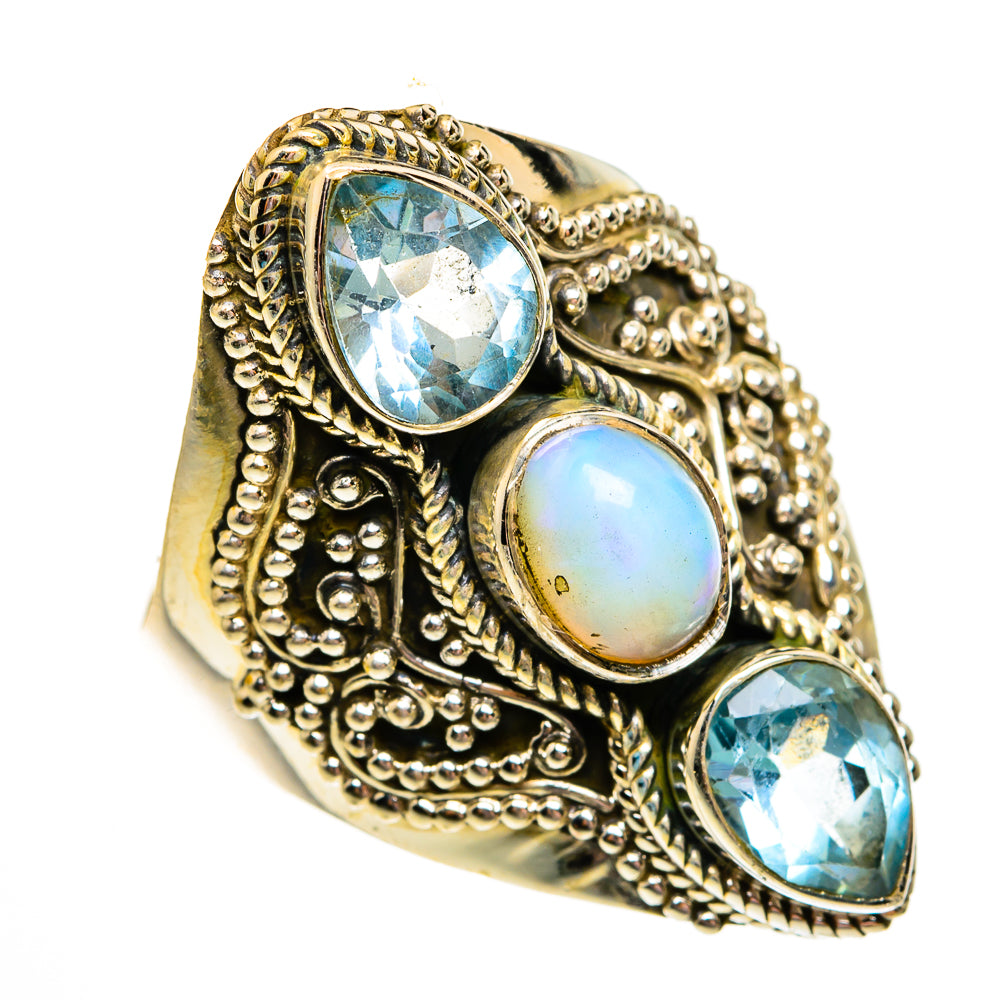Ornate metal statement ring with two oval blue stones and a round light-blue opal center