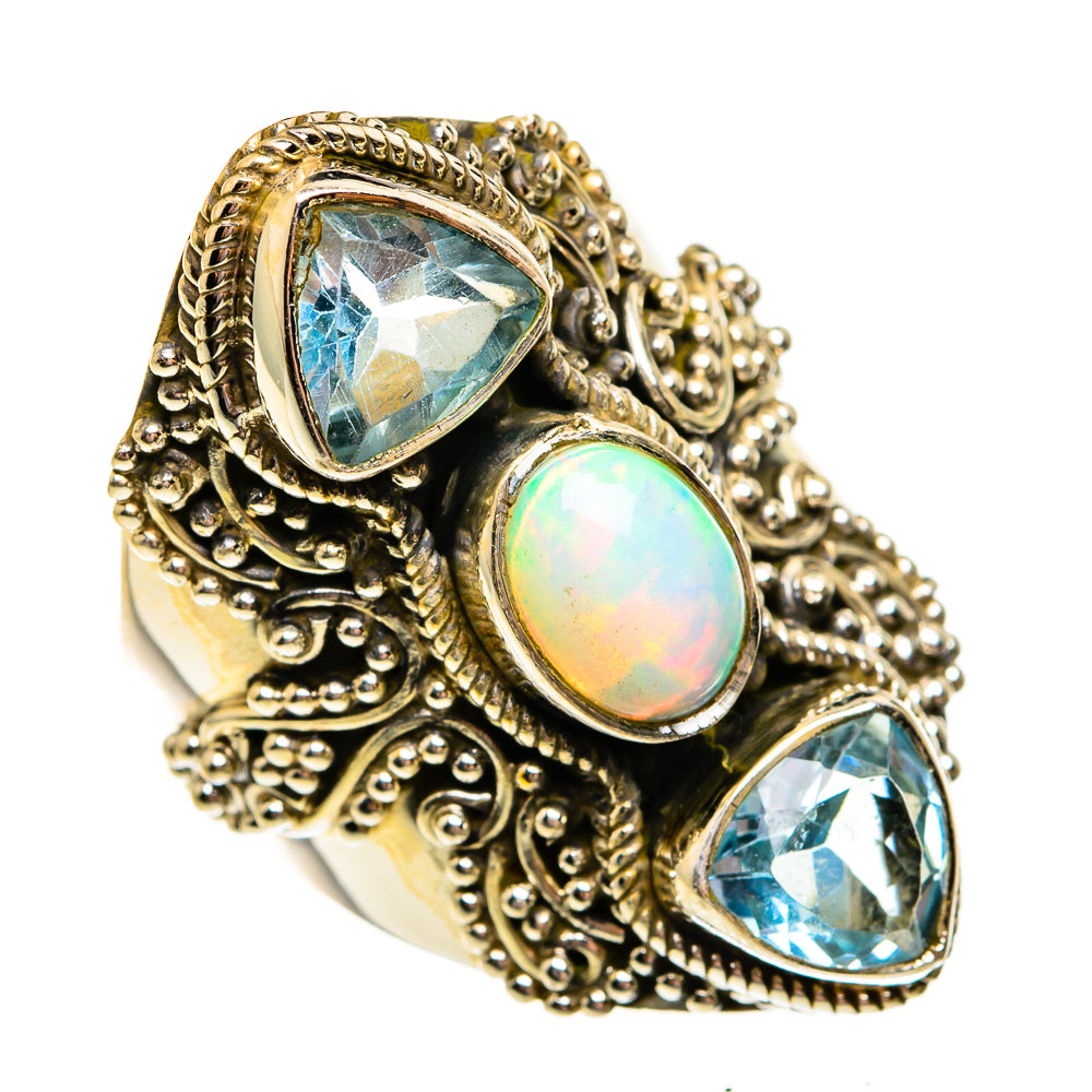 Sterling silver filigree ring with oval opal center and two blue gemstone accents