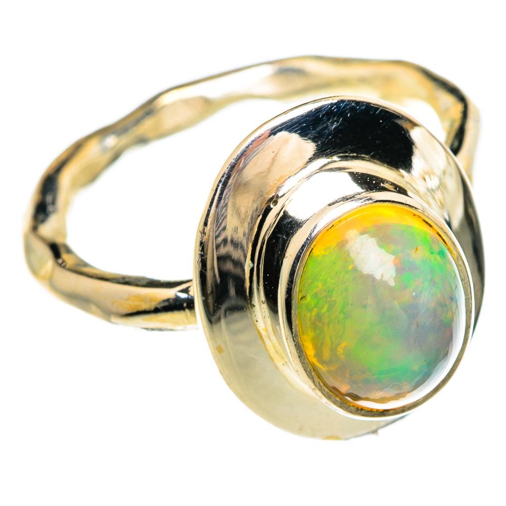 Sterling silver opal ring with bezel-set oval cabochon and textured raised band.
