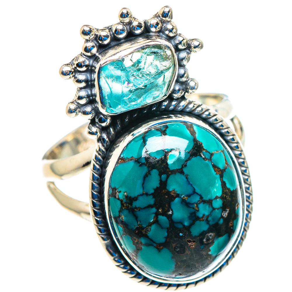 Oval turquoise cabochon silver ring with ornate bezel and small blue accent stones