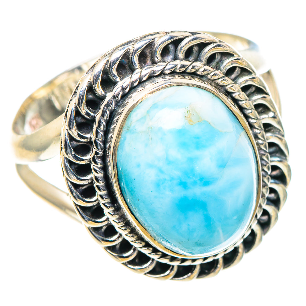 Silver oval gemstone ring with light-blue cabochon and braided outer halo