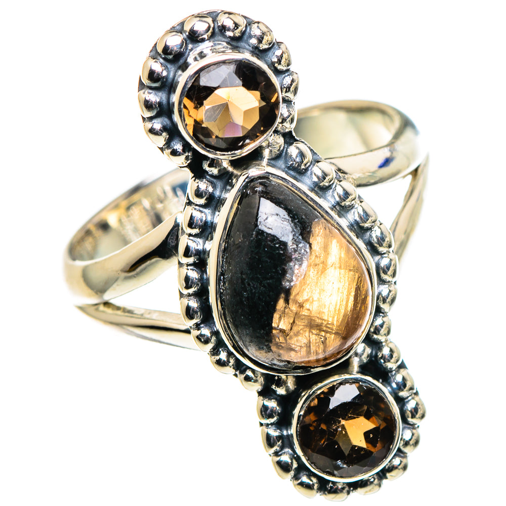 Sterling silver ring with oval amber gemstone, dark round stones, and textured bezel