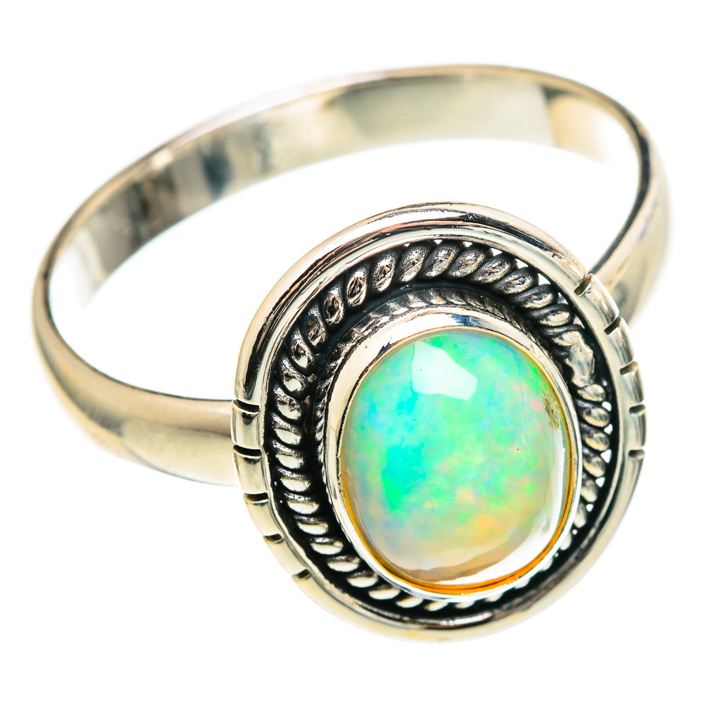 Sterling silver opal ring, round turquoise-green gemstone in patterned bezel on slim band