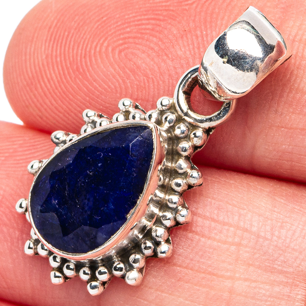 Oval blue sillimanite pendant in ornate sterling silver bezel, bail top