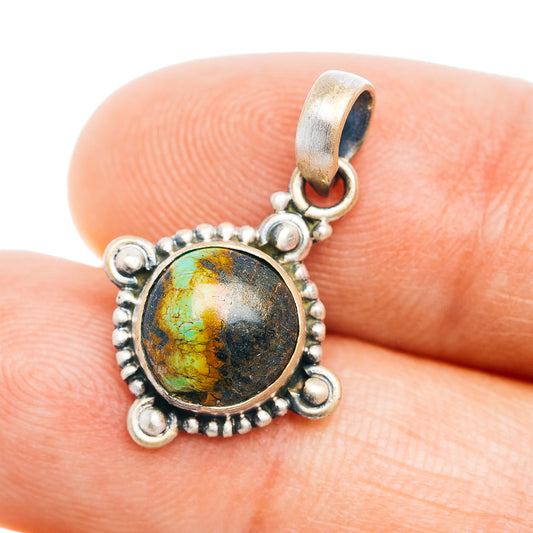 Sterling silver pendant with round turquoise cabochon and beaded bezel bail
