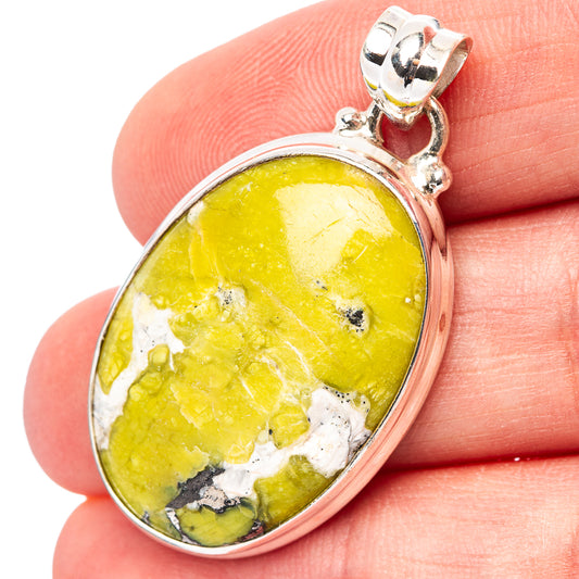 Lizardite pendant in .925 sterling silver bezel with yellow-green oval stone, top bail