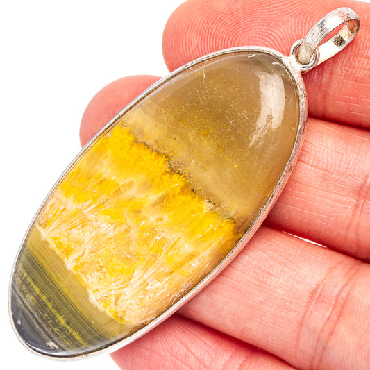 Silver-plated oval jasper pendant with honey-yellow stone and dark band, top bail