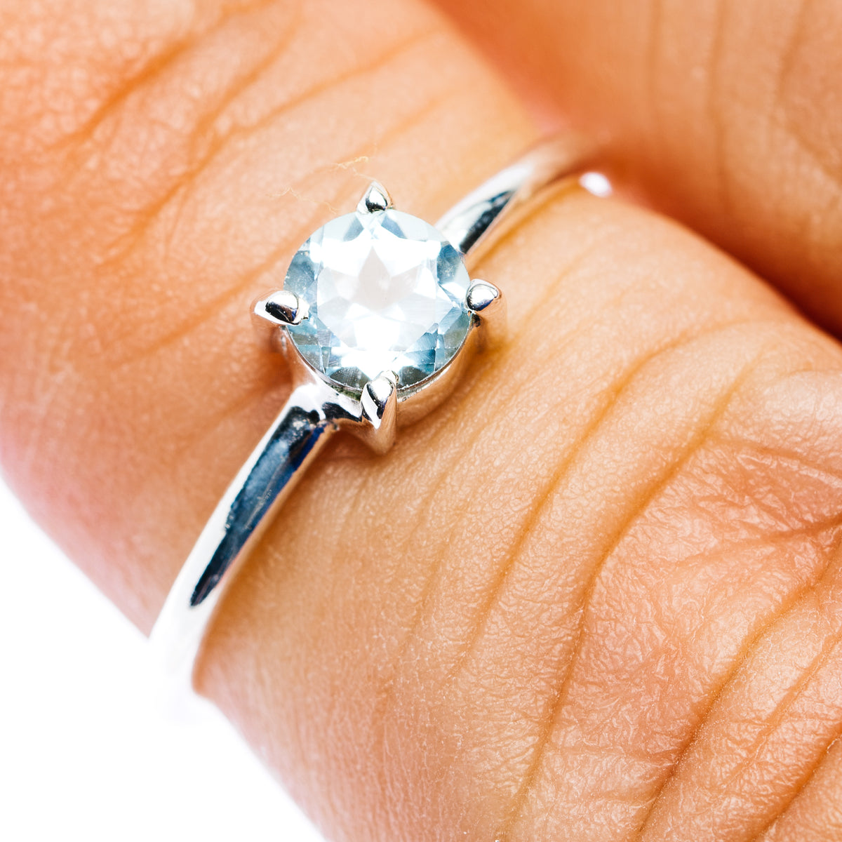 Blue topaz stackable ring, round prong-set stone on .925 sterling silver band