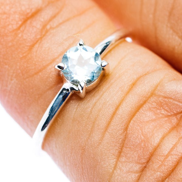 Blue topaz stackable ring, round prong-set stone on .925 sterling silver band