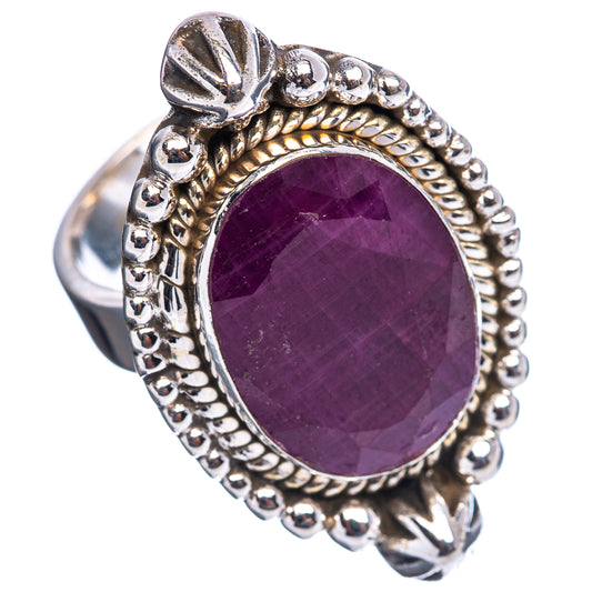 Oval dark purple ruby ring with carved bezel and bead detailing