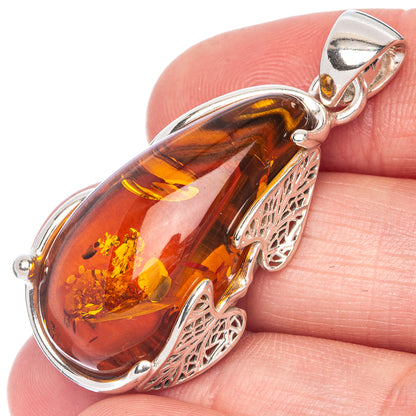 Amber teardrop pendant in 925 sterling silver, with ornate filigree frame.