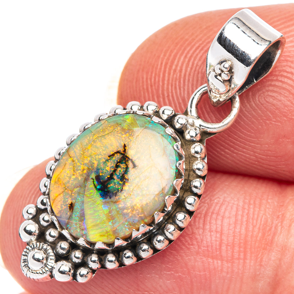 Sterling silver opal pendant with oval opal cabochon and beaded halo setting