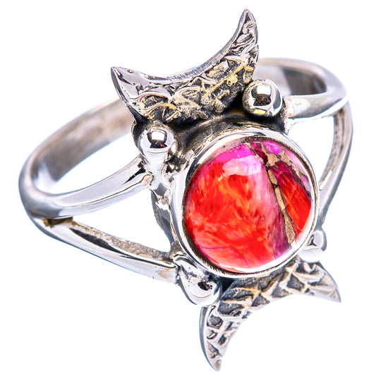 Sterling silver ring featuring oval pink-red cabochon in star-shaped native setting.