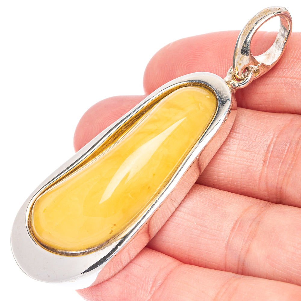 Oval amber pendant with yellow cabochon in 925 sterling silver bezel and bail