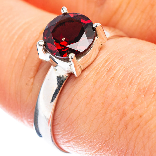 Sterling silver garnet ring with faceted round red gemstone, size 8.25