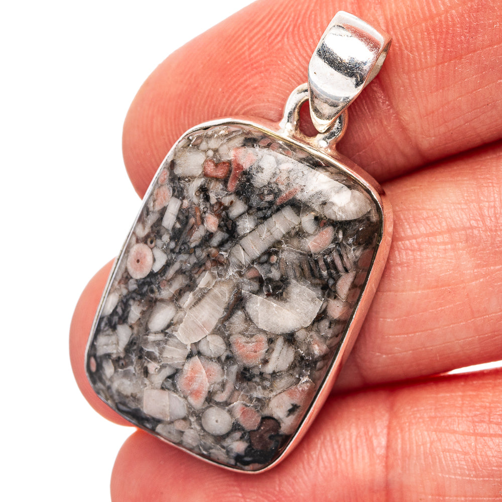 Sterling silver crinoid fossil pendant with rectangular bezel, speckled stone center
