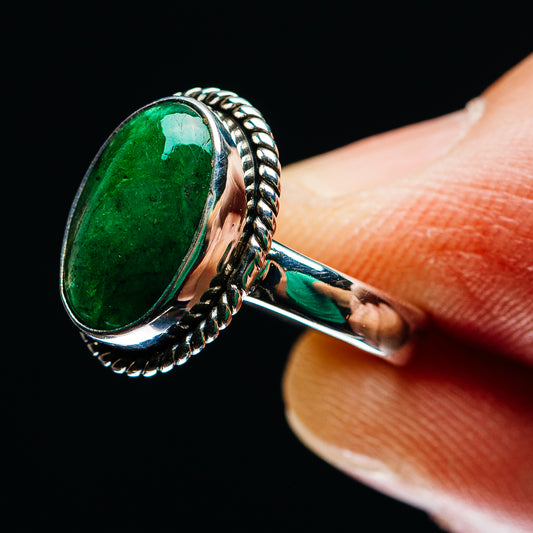 Side view of oval green emerald ring in .925 sterling silver with rope-textured band